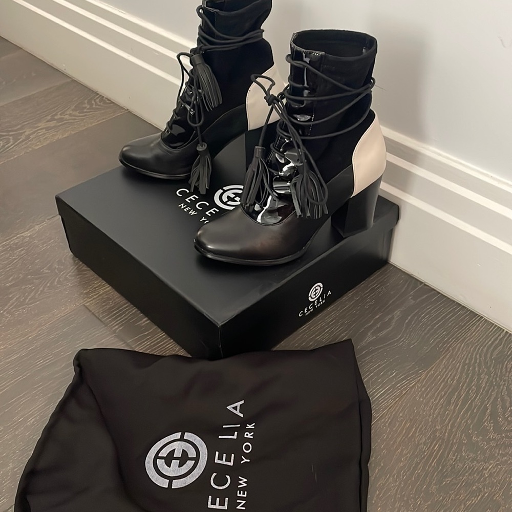 Black and white leather/suede laced up bootie. Size 7.5